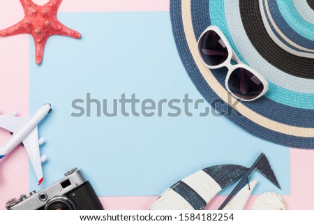 Travel concept with airplane, camera and beach items. Top view flat lay with copy space