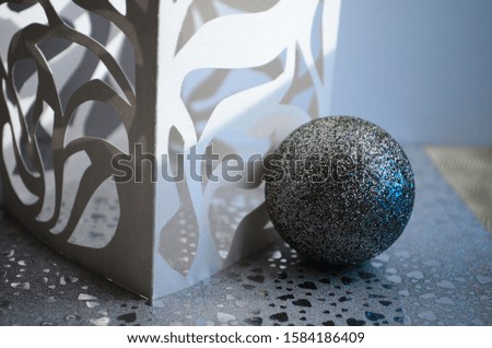 carved paper composition with christmas toy and bokeh close up