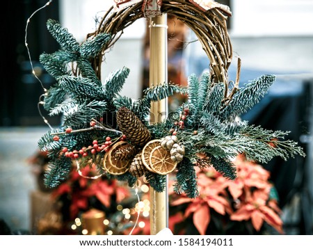 closeup of pine branches with slices of lemon and pine cones in a Christmas wreath