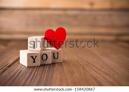 Love message written in wooden blocks. Red heart.