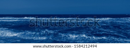 Color of the year 2020 classic blue. Stormy sea and classic blue sky in summer sunny day. Beautiful natural panoramic background with space for text. Fashionable pantone color trend concept, banner