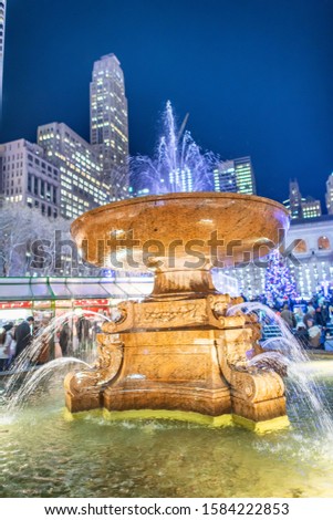 Fountain of Bryant Park at night in winter, New York City.