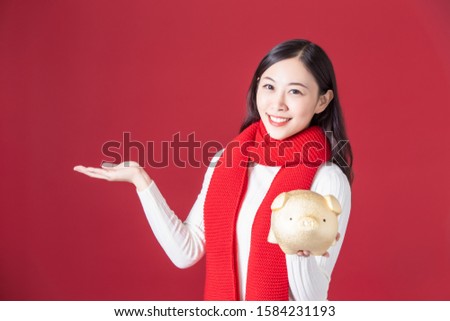 asian woman hold piggy bank and show something