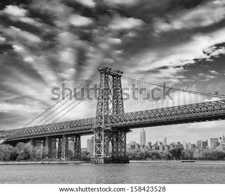 Beautiful structure of Manhattan Bridge against a dramatic colourful sky - New York.