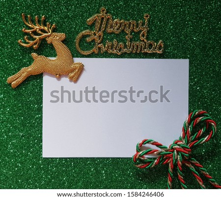 Creative Merry Christmas background with word, bow tie, deer and white blank paper for text. 
