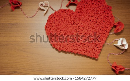 Valentine's Day, February 14th. Red and white heart on a wooden background. With candles and a red silk ribbon. Present. 
