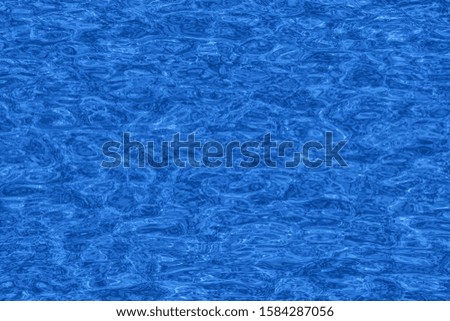 Color of the year 2020 concept. Flat lay Minimal creative sea water background toned in classic blue color.