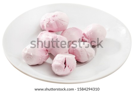 Picture of tasty french goat cheese  stuffed with raspberries at plate. Isolated over white background