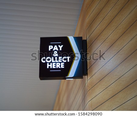 Pay and Collect here sign board 