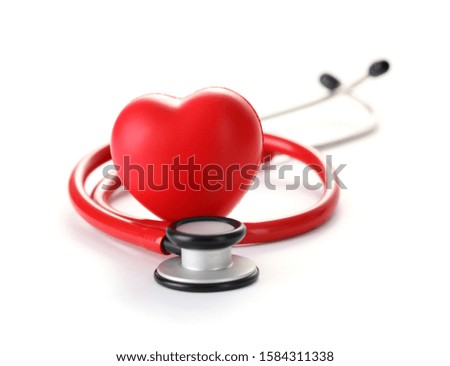 Close-up of main human organ. Macro shot of red plastic heart and medical stethoscope. Cardiological illness and medicine concept. Copy space in right side. Isolated on white