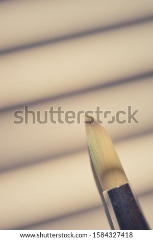 One brush for painting on the sunny paper with shadow stripes