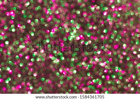 Abstract sparkle background. Shiny glitter bokeh in pink and green colors. 