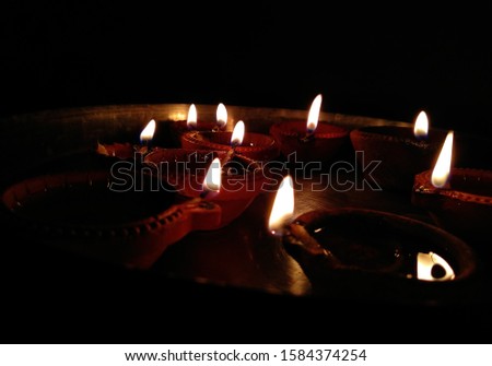 Some glowing candles/diya on floor on the Diwali night celebration. festive religious on objects and background. Candle. Valentine day