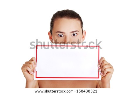 Shocked woman holding blank board, isolated on white