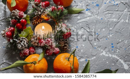 mandarin. tangerines with leaves on a vintage wooden background. Green leaves of tangerines. Christmas tree branches and candles. copyspace
