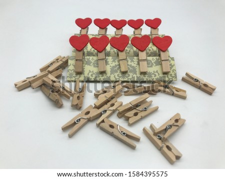 macro shot of red love heart made from different alternative compositions on wooden pegs on white background Buy detail