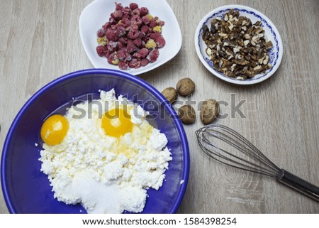 Cooking Cupcakes. In a bowl of eggs, flour. On a wooden background.
