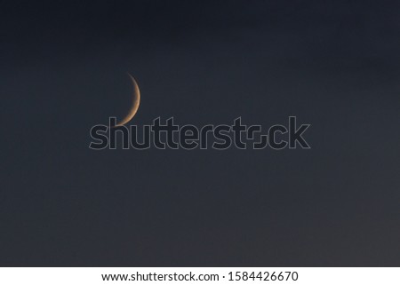 dark evening sky and half moon