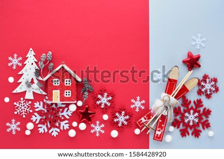 Christmas or New Year greeting card. Christmas decorations on red and gray background. Flat lay, top view, copy space
