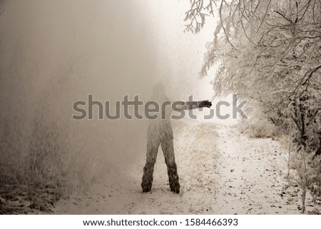 Silhouette of a woman enjoying heavy snowfall