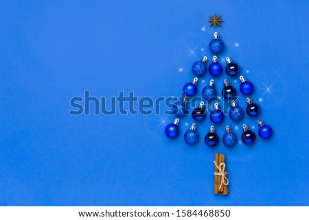 Creative Christmas tree made of blue bauble and star decoration isolated on color of the year 2020 classic blue background. Merry christmas, Happy New year concept Flat lay Top view Place for text  