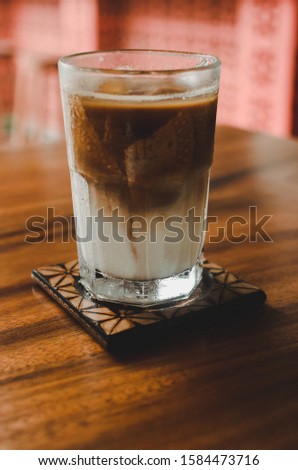 iced coffee regal above wooden table