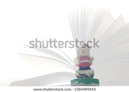 Stacked images of Santa Claus candles On the background of the open book