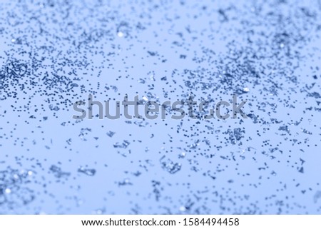 confetti and stars and sparkles on Classic Blue Christmas background. Top view, flat lay. Copyspace for text. Bright and festive holiday background. Color of year 2020.