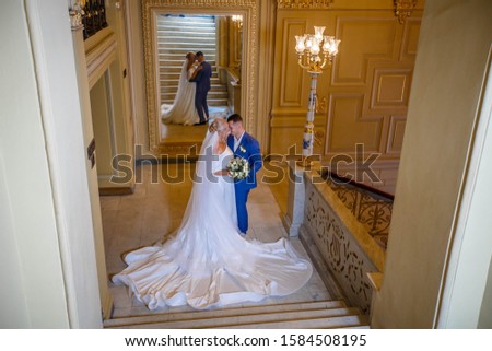 Loving couple near a large elegant mirrors in opera
