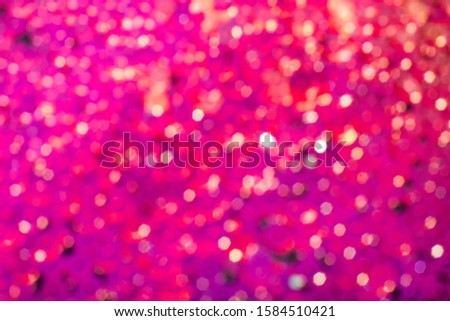 Abstract background with magenta glitter bokeh lights.