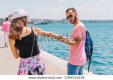 Couple walking next to the sea and having fun.