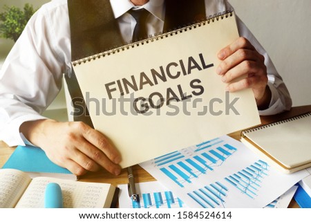 Business photo shows hand written text Financial Goals
