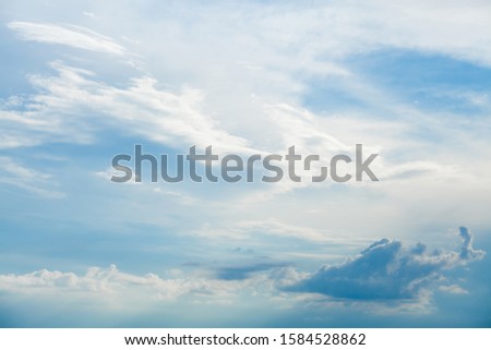 Background of white cumulus clouds on a blue sky at daylight. Telephoto zoom shoot