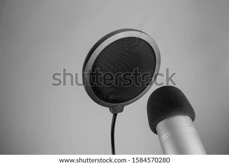 professional microphone for recording sound for a blogger or radio on a gray background