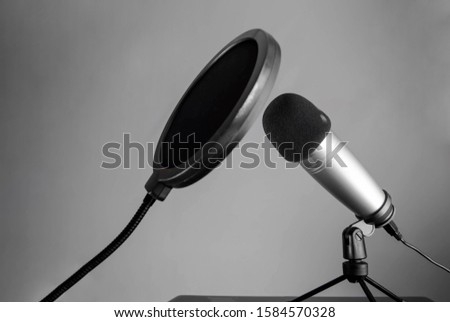 professional microphone for recording sound for a blogger or radio on a gray background