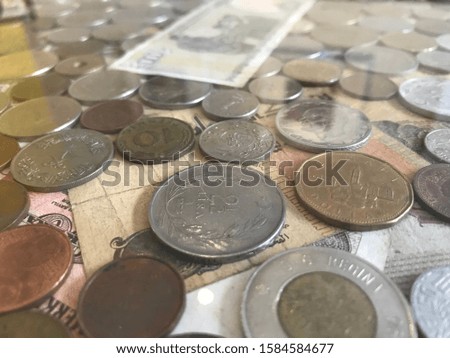 Old paper metal coins Buying Turkish coins on a old 10 lira coffee table on a coffee table conceptual money shoot finance money bank lined up under the glass.