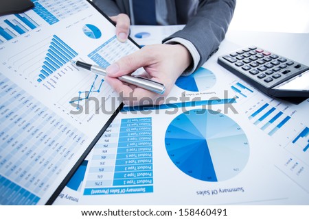 man hand with pen and business report Royalty-Free Stock Photo #158460491