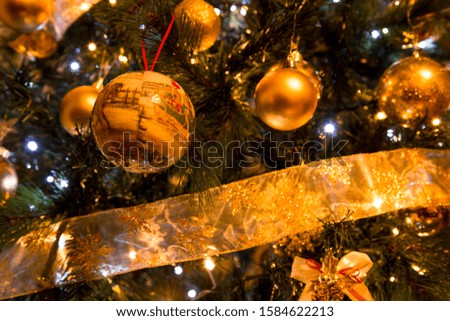 Christmas decorations placed on a Christmas tree, with lights and glitters