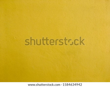 Yellow cement wall background and texture