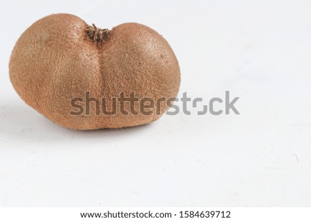 The ugly kiwi fruit. Tasty and healthy. Vegetarian food. On a light background. Copy space.