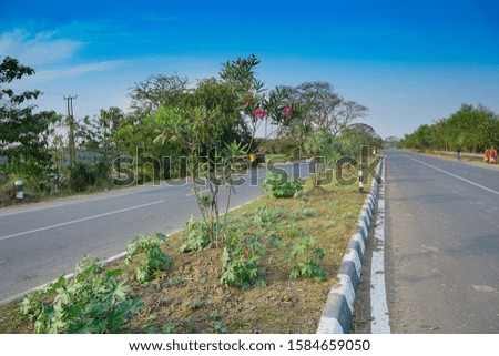 National highway of India with concrete made road, blue sky above. Stock image.