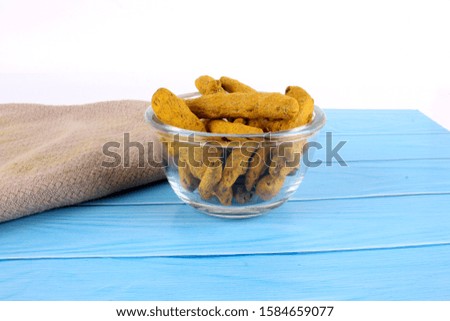 Turmeric on bowl Isolated in blue