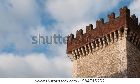 Ghibelline battlements on italian medieval castel Royalty-Free Stock Photo #1584715252
