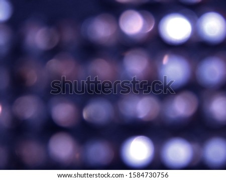 White silver festive blurred lights on dark blue violet black background.Shiny bokeh. Abstract defocused lights.Glowing effect concept.Blur lights in dark night. Illuminated decoration photo wallpaper