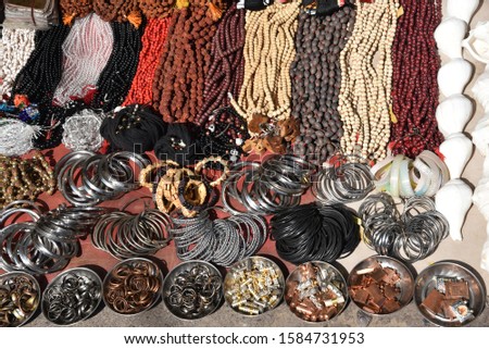 group of Bracelet, amulet, ring and string of beads for men display at rural street shop in the market for sale 