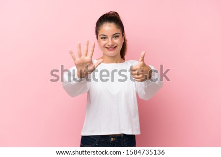 Young brunette girl over isolated pink background counting six with fingers