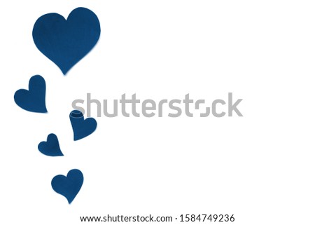Valentines Day card background, classic blue cute hearts made of paper. White background with hearts in paper cut in different size. Valentine Day romantic. Copyspace