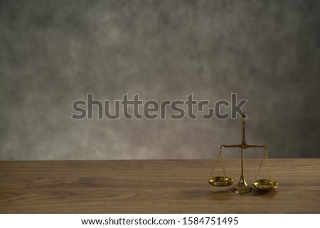 Law and Justice concept. Mallet of the judge, scales of justice. Gray stone background,  place for typography. Courtroom theme.