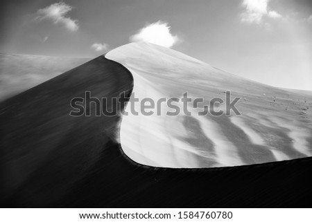 black and white image from the formation of sand dunes in dasht e lut desert