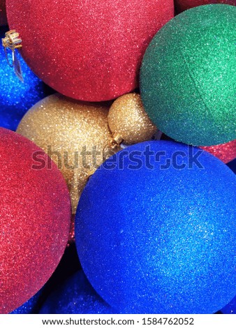Blurred Colorful shiny Christmas ball background. Top view. New year decoration. Christmas sparkling decoration balls.  Glittering balls for new year tree. Selective focus. Vertical position 